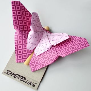 Paper butterfly on clothes peg